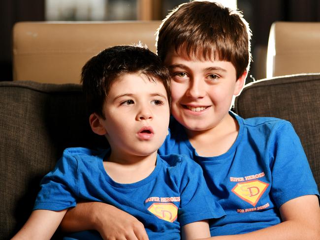 Henry Dray 7, battles with the rare disease Dup15q. Pictured with brother William Dray 10 and their designed t-shirts for 'Superheroes for Super Dupers' . Picture: Alix Sweeney