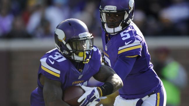 Teddy Bridgewater hands off the ball to teammate Jerick McKinnon.