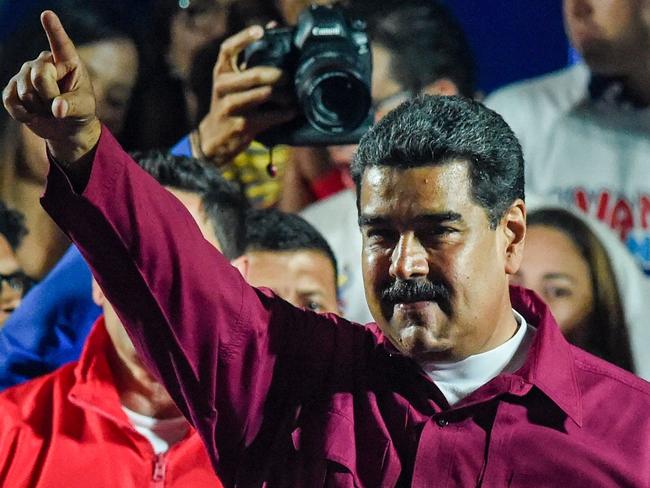 TOPSHOT - Venezuelan President Nicolas Maduro gestures after the National Electoral Council (CNE) announced the results of the voting on election day in Venezuela, on May 20, 2018. President Nicolas Maduro was declared winner of Venezuela's election Sunday in a poll rejected as invalid by his rivals, who called for fresh elections to be held later this year. With more than 90 percent of the votes counted,  Maduro had 67.7 percent of the vote, with his main rival Henri Falcon taking 21.2 percent, the National Election Council chief Tibisay Lucena announced. / AFP PHOTO / Juan BARRETO