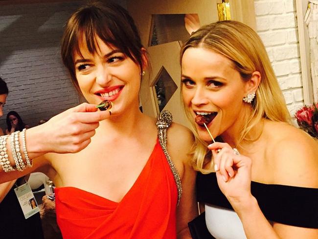 Reese Witherspoon got stuck into the canapés with Fifty Shades star Dakota Johnson.