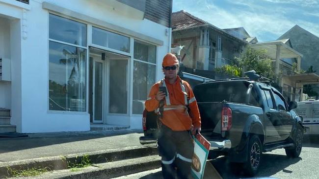 An Ausgrid employee removing a corflute in Sydney’s eastern suburbs. Picture: supplied.