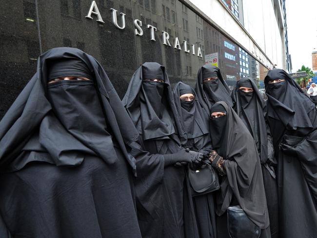 A group of people dressed in burqas from the group 'Faceless', call for the banning of the conservative Muslim apparel throughout Australia during a rally in Sydney in 2012. AFP PHOTO/Torsten Blackwood