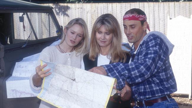 Australian actress and singer Olivia Newton-John (C) with her husband Matt Lattanzi and cyclist/babysitter Cindy Jessup at Olivia's home 1994. Picture: Peter Carrette Archive/Getty Images.