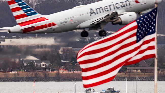 A plane takes off above the crash site. Picture: Al Drago/Getty Images via AFP