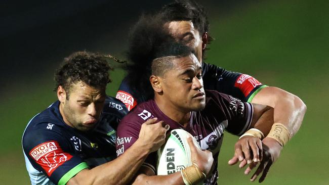 Moses Suli is claimed by the Raiders defence.