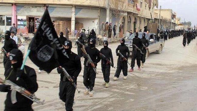 Islamic State group, marching in Raqqa, Syria. As U.S.-backed forces bear down on the city, the militants have been preparing defenses of their de facto capital. Tarps have been put under streets to hide movements underneath, and sandbags and earthen beams have gone up. Iraqi and Syrian fighters .