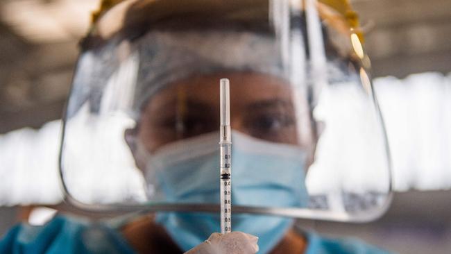 A health worker prepares a dose of Covid-19 vaccine at an inoculation centre in Lima, Peru, last month. Picture: AFP