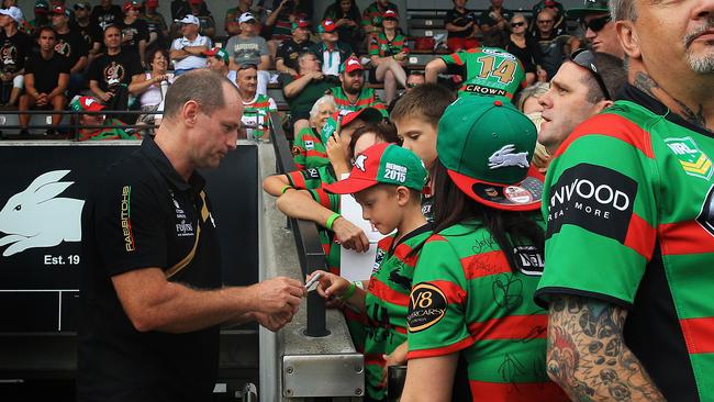 South Sydney Rabbitohs coach Michael Maguire took a break from worries surrouding a fresh NRL Integrity Unit investigation to hand out jerseys to Juniors on Thursday afternoon. He is pictured signing autographs at a game against the Northern Pride on Saturday. Picture: Mark Evans.