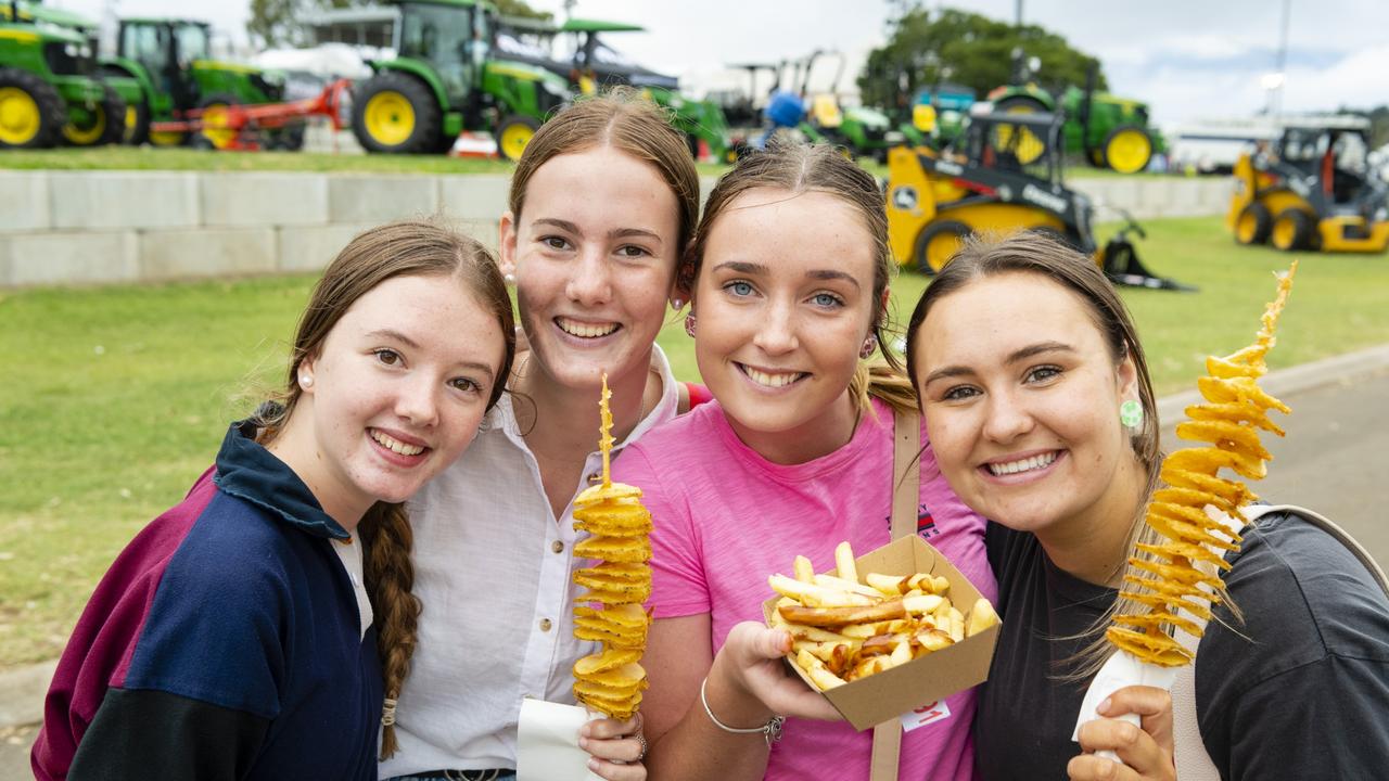 Enjoying their snaks are (from left) Izzy Sheppard, Molly Gore, Emma Fitzgerald and Mackenzie Hartog at the 2022 Toowoomba Royal Show, Friday, March 25, 2022. Picture: Kevin Farmer