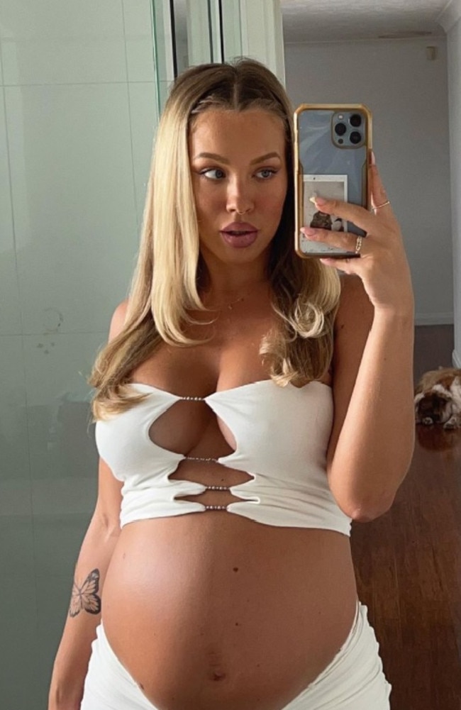 Tammy Hembrow, 27, flaunting her baby bump in a white crop and matching skirt. Picture: Instagram/tammyhembrow