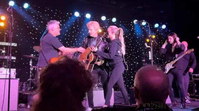 Don Felder is held up on stage during a “medical emergency” on-board The Rock Legends Cruise. Picture: YouTube