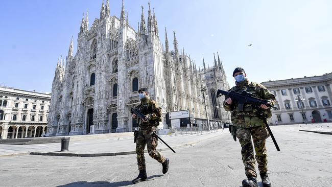 Soldiers patrol in front of the Duomo gothic cathedral in Milan, Italy. Picture: AP