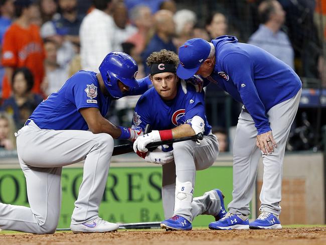 Albert Almora Jr. is comforted by manager Joe Maddon and Jason Heyward. Picture: Bob Levey/Getty Images/AFP