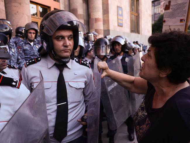 A woman confronts Armenian police officers during a demonstration following Azerbaijani military operations against Armenian separatist forces in Nagorno-Karabakh. Azerbaijan and Armenian separatists from the disputed territory held their first peace talks this week after Baku claimed to have regained control. Picture: Alain Jocard/AFP