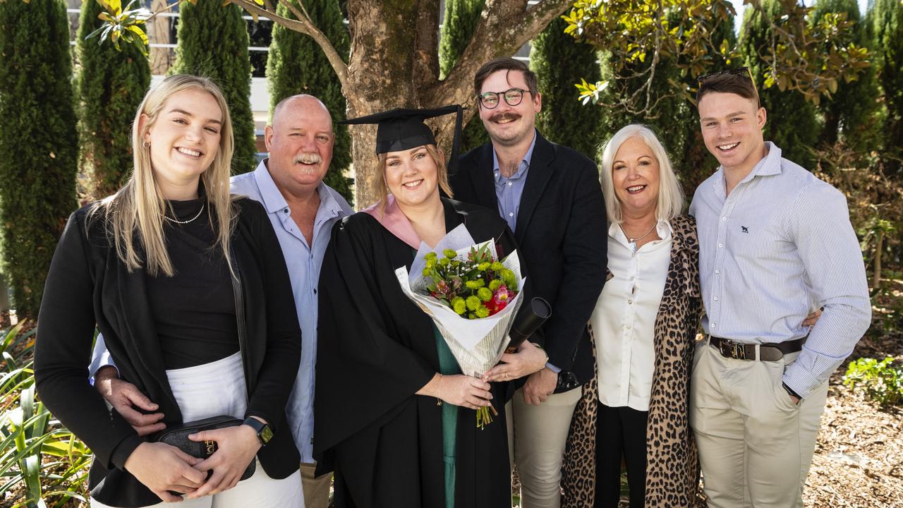 Bachelor of Education (Secondary) graduate Sarah Skinner celebrates with (from left) Katie Skinner, Jim Skinner, Luke Titmarsh, Fiona Skinner and Tom Skinner at UniSQ graduation ceremony at Empire Theatres, Tuesday, June 27, 2023. Picture: Kevin Farmer