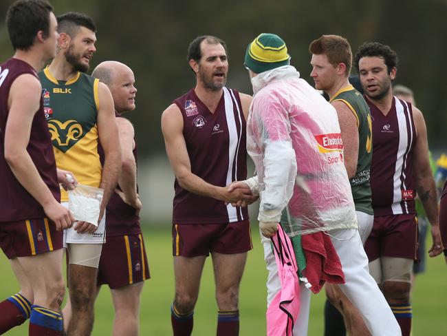 Amateur footy division seven - O'Sullivan Beach/Lonsdale v Marion. OSB Lonsdale's Trevor Rigney is congratulated by all for kicking 100 goals this season. At Lonsdale 4 August 2018. (AAP Image/Dean Martin)