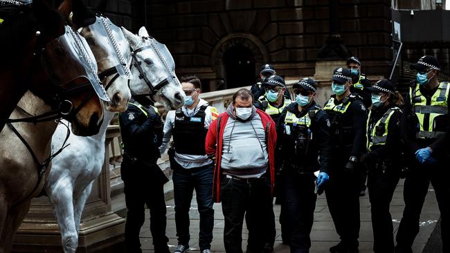 A man is detained by police on Sunday after an anti-lockdown protest in the city. Picture: Getty