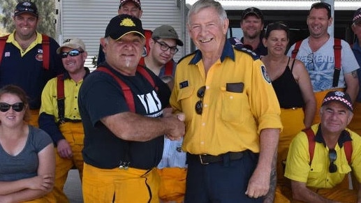 Fred Turner (right) congratulating the Victorian volunteers in 2019 who assisted in fires in the Hunter. Supplied.