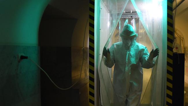 A medical worker walks through a disinfection cabin at the Covid-19 unit of the Mariinsky Hospital in Saint Petersburg. Picture: AFP