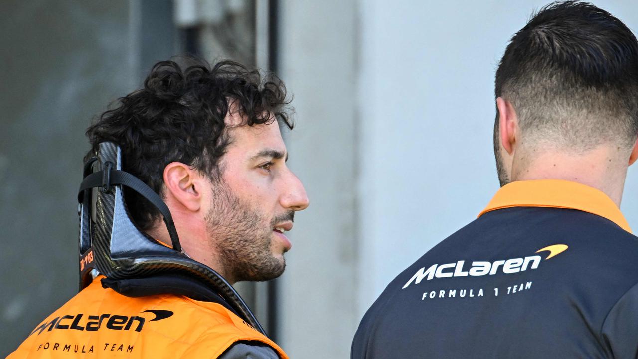 Daniel Ricciardo talks to a technician in the pits during the qualifying session of the Red Bull Ring race track in Spielberg, Austria,.