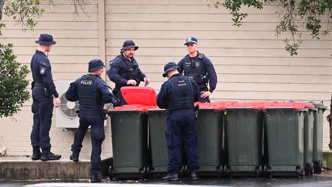 Officers search bins in Webb Street. Picture: NCA NewsWire / Jeremy Piper