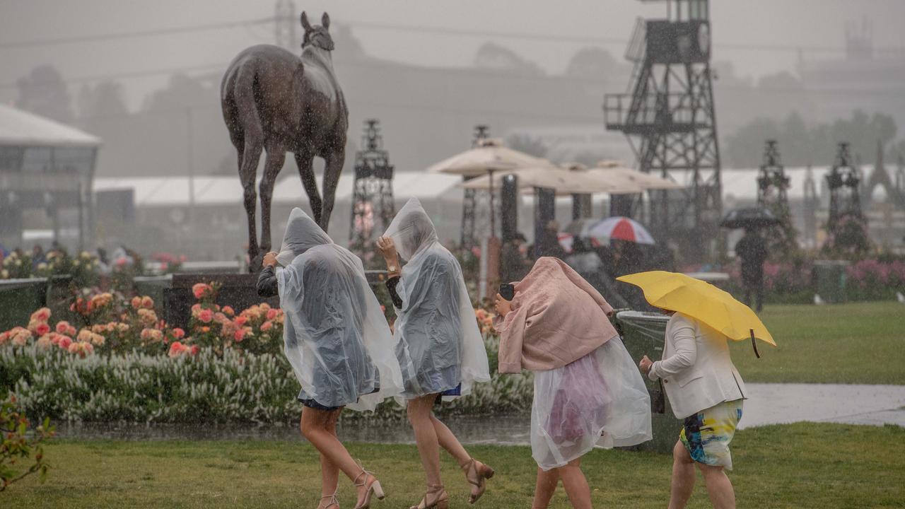 Punters make their way past the statue of three-time Melbourne Cup winner Makybe Diva, a well known mudlark.  icture: Jason Edwards