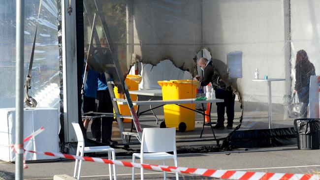 Workers inside the damaged marquee. Picture: Andrew Henshaw