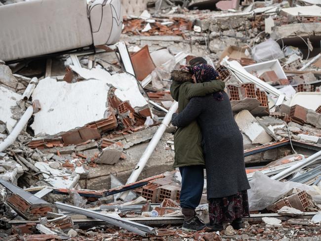 Women hug each other near a collapsed building near Gaziantep, Turkey. Picture: Getty Images.