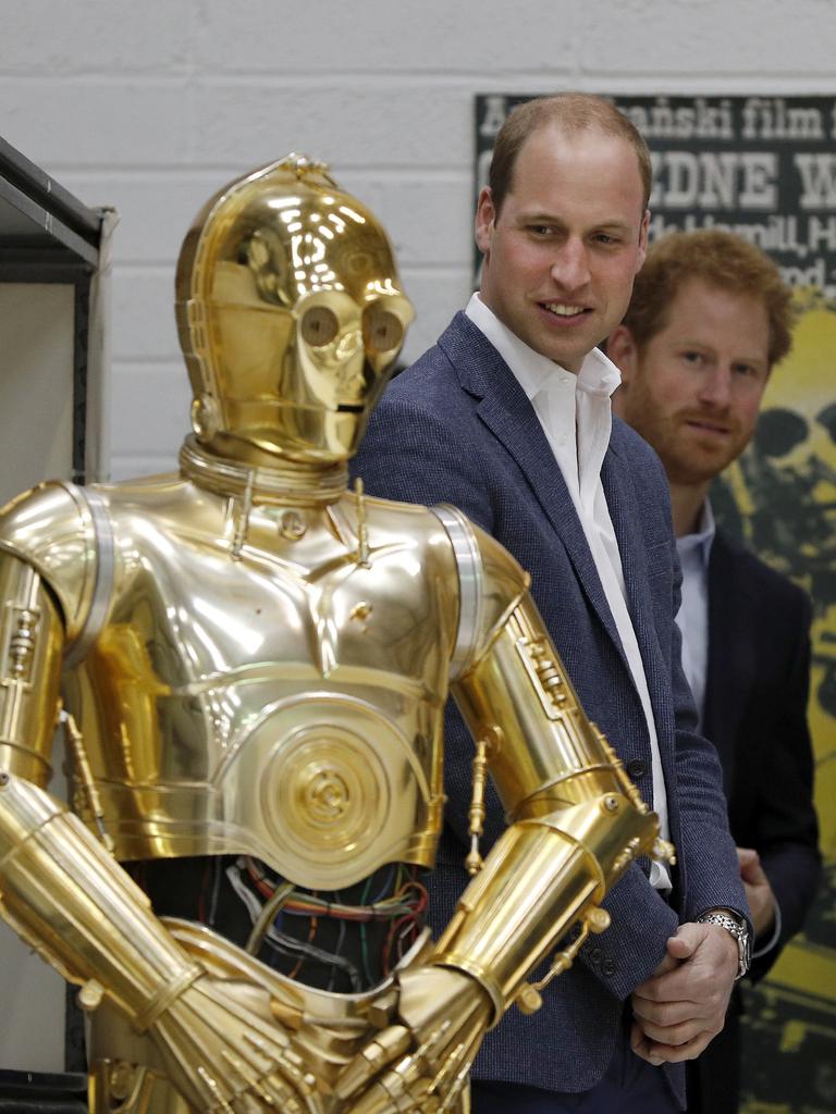 Britain Prince William, centre and, Britain’s Prince Harry look at Star Wars character the droid C3P0 as they visit the creature and droid department at Pinewood studios in Iver Heath, west of London on Tuesday April 19, 2016. Picture: AP