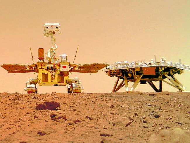 (FILES) This undated handout photograph released on June 11, 2021 by the China National Space Administration (CNSA) shows an image taken by a camera released from China's Zhurong Mars rover showing the rover (L) and the landing platform on the surface of Mars. A Chinese rover has found new evidence to support the theory that Mars was once home to a vast ocean, including tracing some ancient coastline where water may once have lapped, a study said on November 7, 2024. (Photo by HANDOUT / China National Space Administration (CNSA) / AFP) / -----EDITORS NOTE --- RESTRICTED TO EDITORIAL USE - MANDATORY CREDIT "AFP PHOTO / CNSA" - NO MARKETING - NO ADVERTISING CAMPAIGNS - DISTRIBUTED AS A SERVICE TO CLIENTS