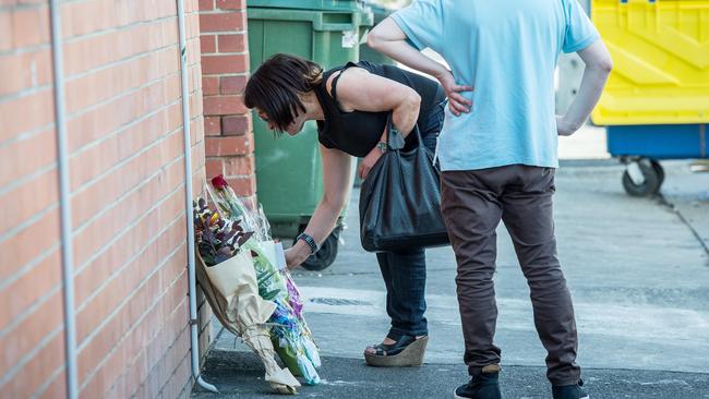 Mourners lay flowers at Joe Acquaro’s murder scene. Picture: Jake Nowakowski