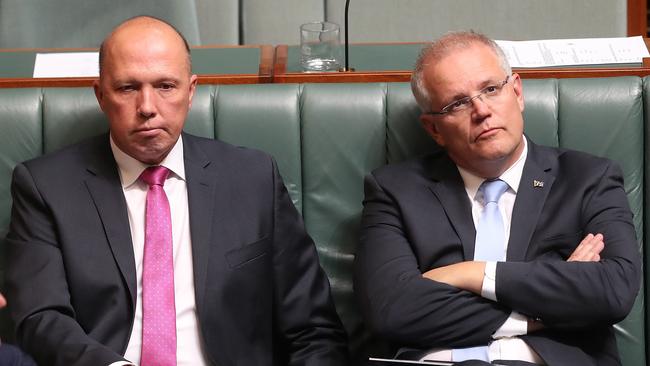 Home Affairs Minister Peter Dutton and PM Scott Morrison during a division in the House of Representatives Chamber at Parliament House in Canberra. Picture. Kym Smith