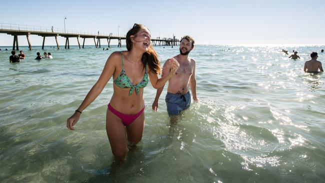 Sophie Prytharch and Jack Grayson, from England, enjoying the Australian sun at Glenelg Beach. Picture: AAP / Morgan Sette