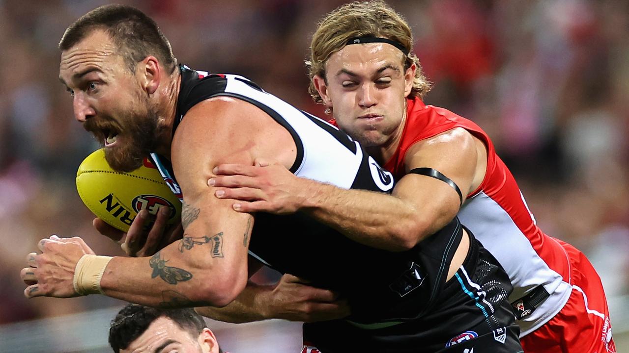 SYDNEY, AUSTRALIA - APRIL 08: Charlie Dixon of Power is tackled by JamesÂ Rowbottom of the Swans during the round four AFL match between Sydney Swans and Port Adelaide Power at Sydney Cricket Ground, on April 08, 2023, in Sydney, Australia. (Photo by Cameron Spencer/Getty Images)