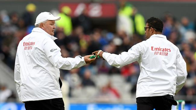 Umpires Marais Erasmus (left) and Kumar Dharmasena bring on some heavier bails. Picture: AFP