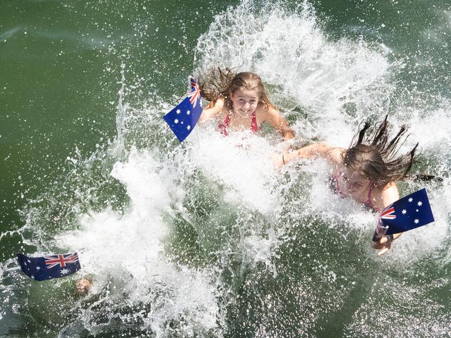 Ava-Jane, 14, Tess, 13, and Chloe, 13 make a splash at Brighton Beach. Picture: Tony Gough