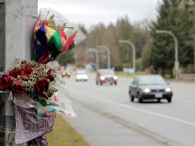 Flowers are taped against a light standard by the side of a busy street following a fatal auto accident serving as a reminder for all of us to "slow down" and drive safe!  See ROADSIDE MEMORIAL clips here!