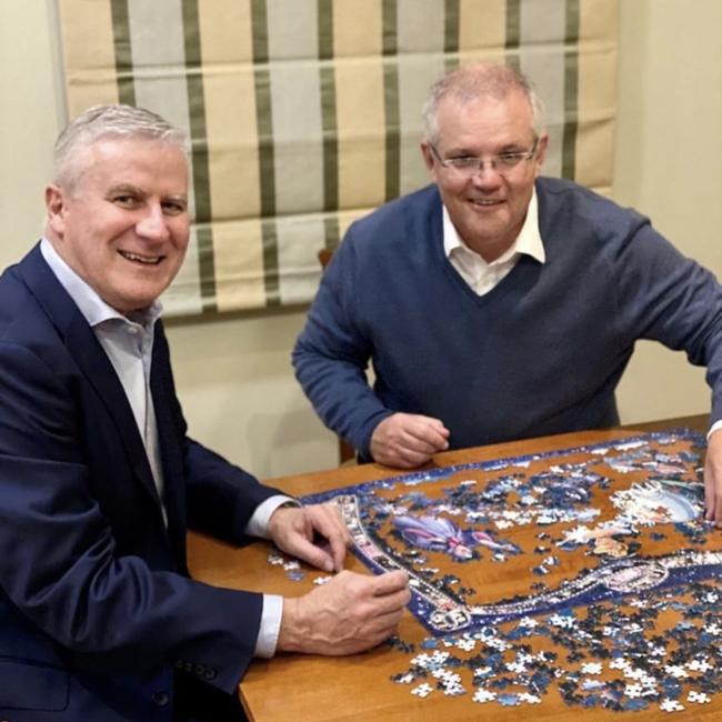 Yes, this really is a picture of Deputy PM Michael McCormack and Prime Minister Scott Morrison working on a DIsney princess puzzle.