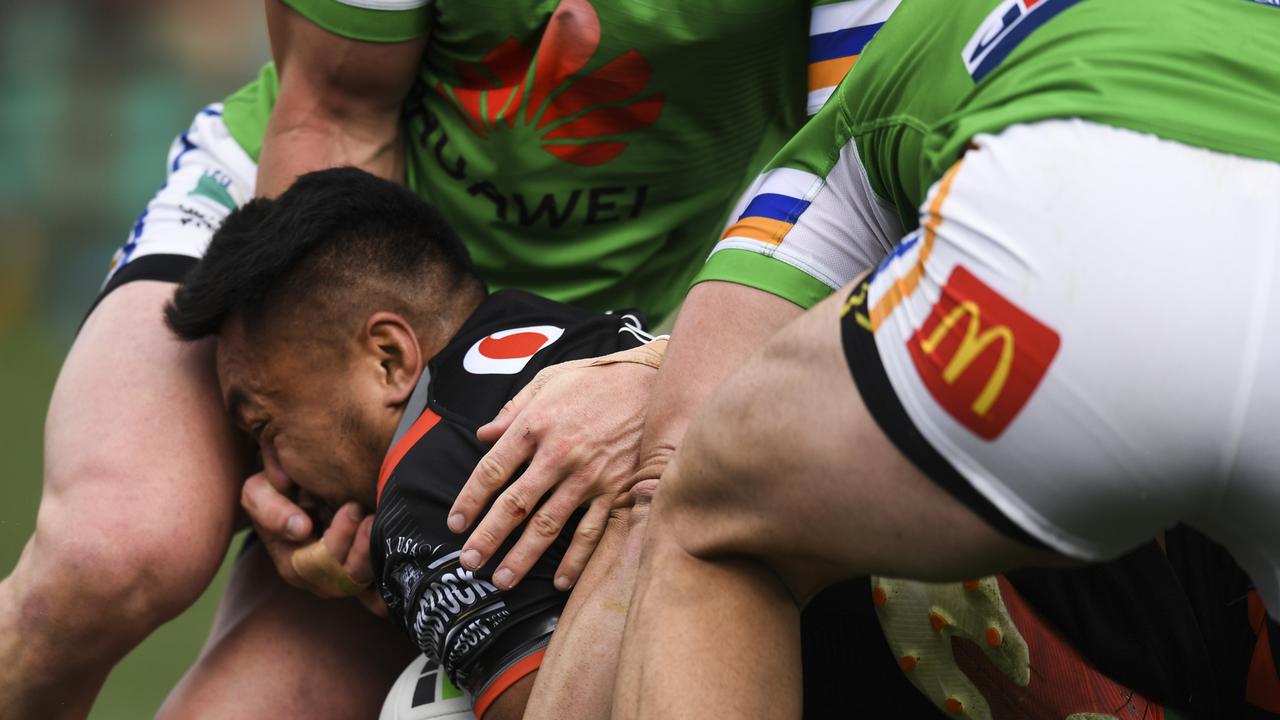 Hudson Young of the Raiders has his hand in the face of Adam Pompey