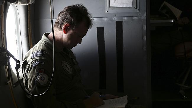 A crew member reads through his notes onboard a RNZAF P3 Orion.