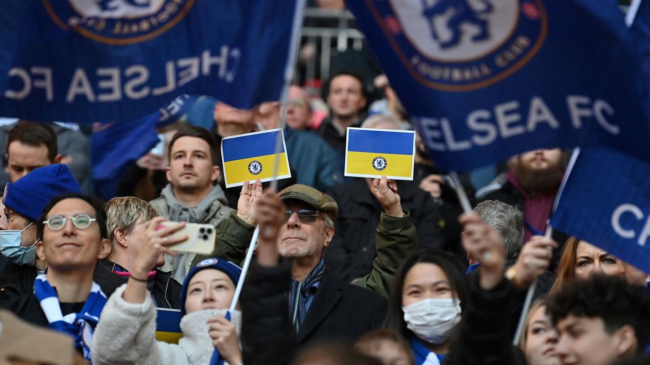 Chelsea supporters hold up Ukrainian flags in the crowd. Photo by Glyn KIRK / AFP.