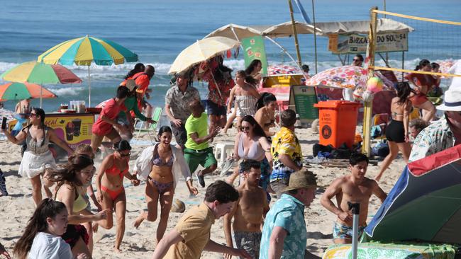 Extras flee the beach during the filming of the Godzilla vs Kong sequel at Surfers Paradise. Picture: Glenn Hampson