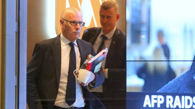 ABC News executive editor John Lyons (left) during the raid on the public broadcaster. Picture: AAP