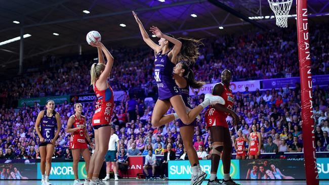 Remi Kamo of the Firebirds attempts to block the shot from Helen Housby of the Swifts during the round three Super Netball match between Queensland Firebirds and NSW Swifts. Photo: Getty Images
