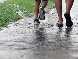 Wet weather makes it a struggle to pick up the children from school. Picture: Brenda Strong