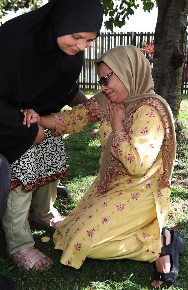 Ambreen Naeem Rashid tries to comfort her older sister who fell to her knees and wept. Picture: Gary Ramage