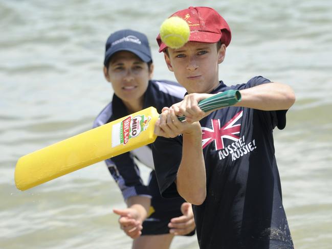 Matthew (11) from Elsternwick spends the last hours of 2009 having a hit of beach cricket at Mills Beach, Mornington with Annie Hatley from Cricket Victoria. Picture: Jason Sammon