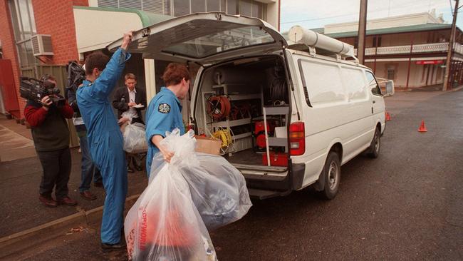 Police remove bags of evidence from the disused bank in Snowtown. Photo: Mark Brake