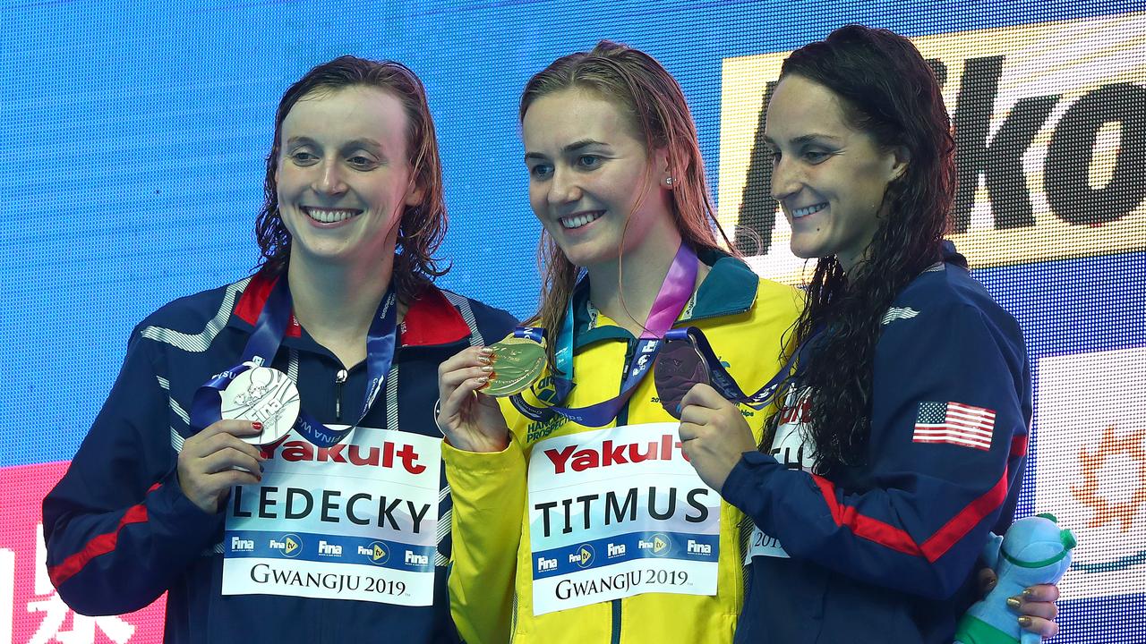 Titmus shows off her gold medal at the FINA World Championships in 2019, ahead of Ledecky with silver and Leah Smith with bronze. Picture: Getty Images