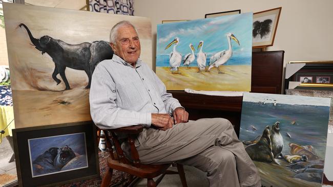 Neil Roberts sits with some of his treasured artwork. Picture: Michael Klein